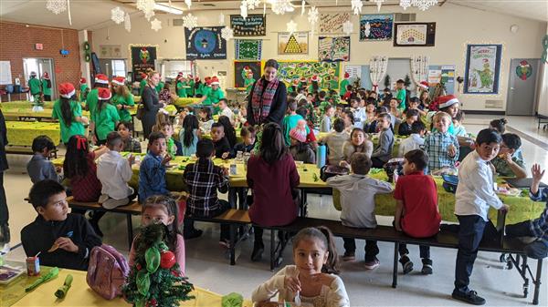 Students dress up and get served a fine meal. 